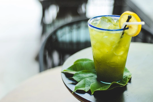 Traditional Balinese herbal green drink with lemon slice