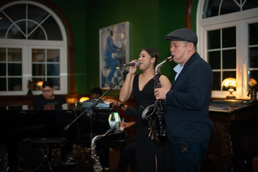 Jazz band performing in a green-walled lounge
