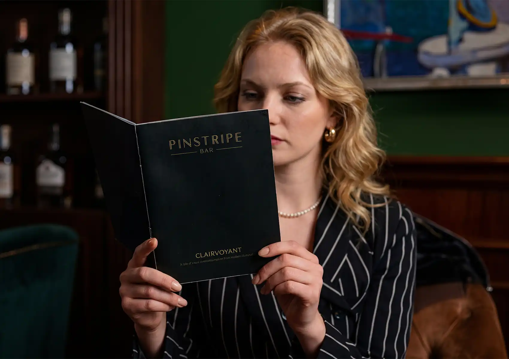 Stylish guest reading cocktail menu in Ubud bar