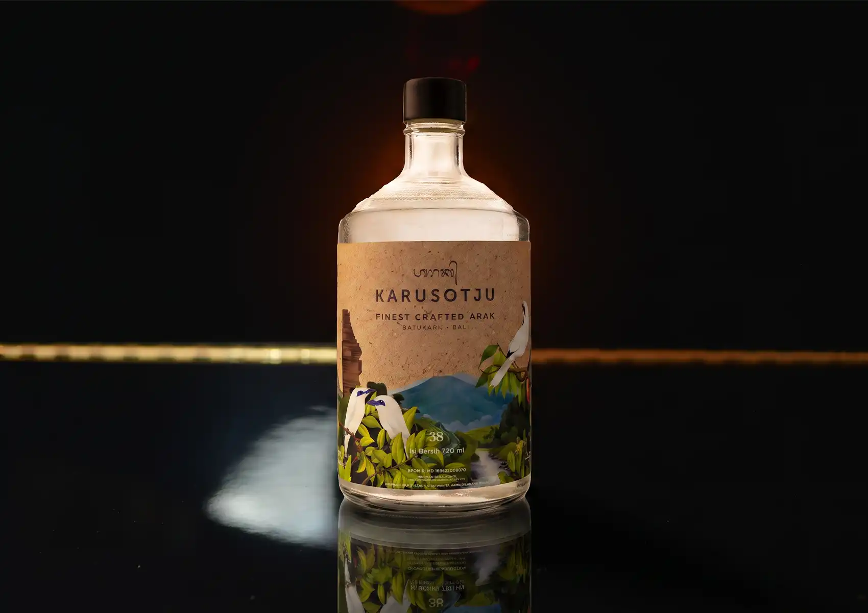 A bottle of Karusotju premium crafted Balinese arak displayed on a dark reflective counter at a cocktail bar ubud.